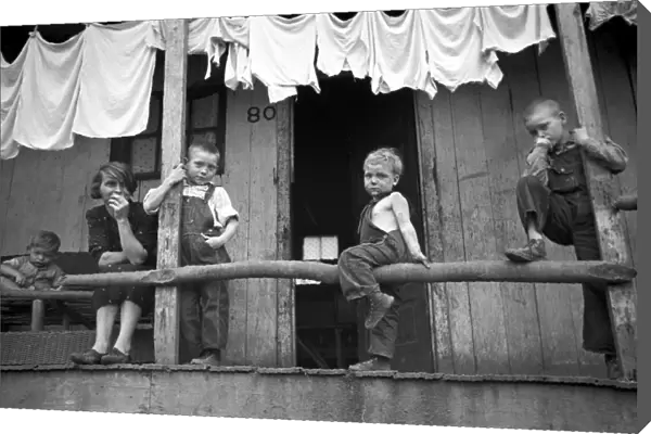 COAL MINERs FAMILY, 1938. Wife and children of a coal miner sitting on a porch in Pursglove