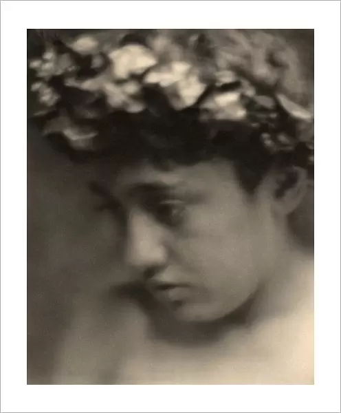 DAY: NUDE WITH LAURELS. Portrait of a nude boy wearing a laurel wreath. Photograph by F