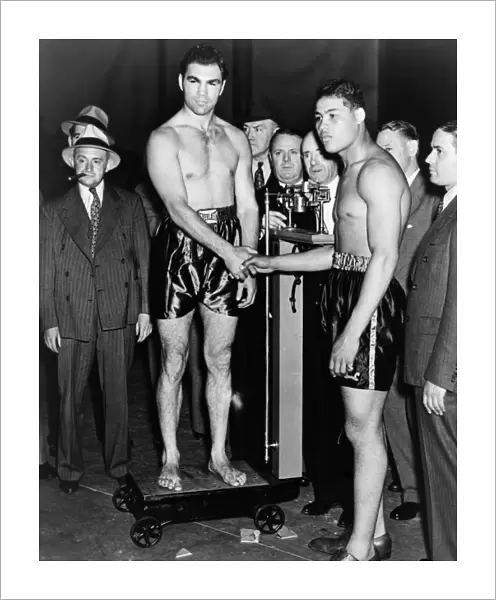 SCHMELING AND LOUIS, 1936. Boxers Joe Louis and Max Schmeling shake hands before