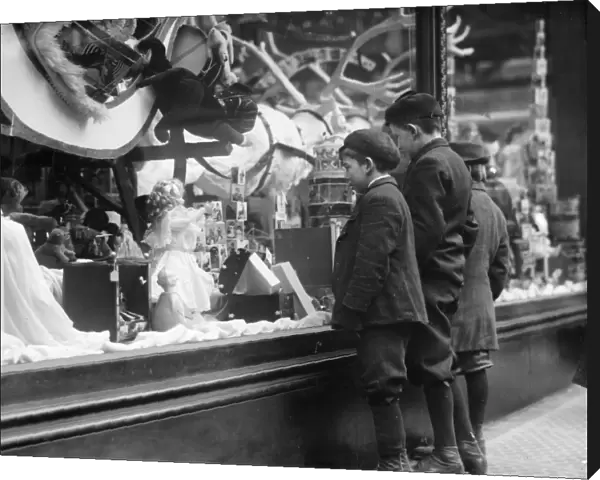 WINDOW DISPLAY, c1910. Boys looking at Christmas toys in a shop window. Photograph