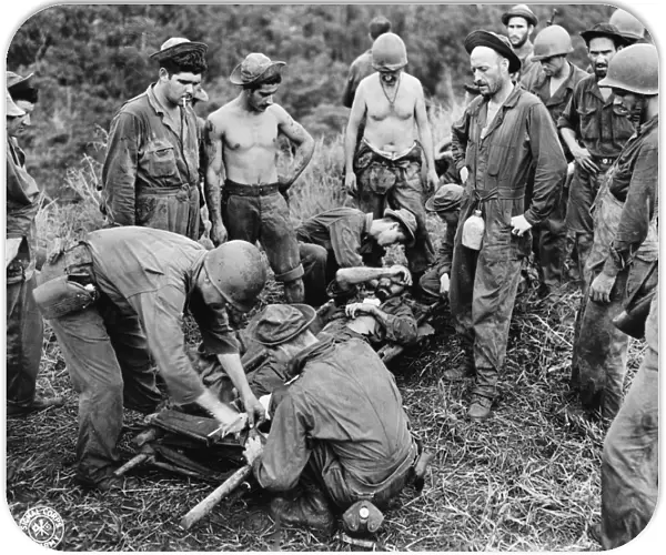 WWII: GUADALCANAL, c1943. A wounded American soldier being taken on a stretcher