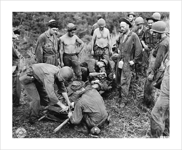 WWII: GUADALCANAL, c1943. A wounded American soldier being taken on a stretcher