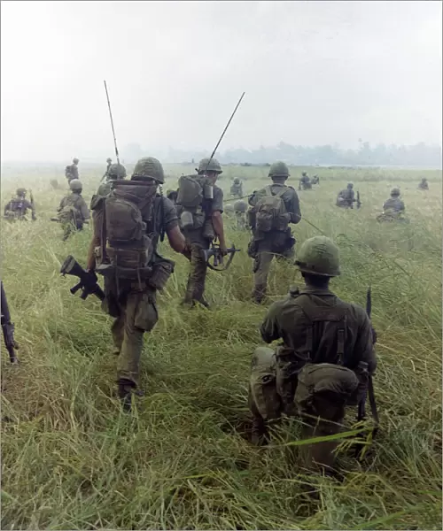 VIETNAM WAR, 1966. Members of the 101st Airborne Division moving across a rice