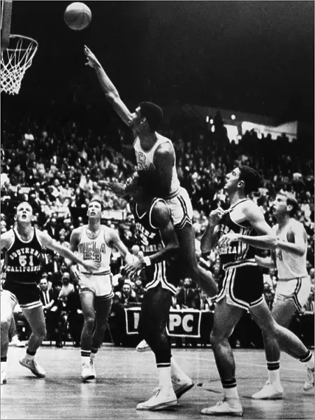 BASKETBALL GAME, 1966. Kareem Abdul Jabbar (Lew Alcindor), playing for UCLA, jumps to make a shot during a game against Southern California, December 1966