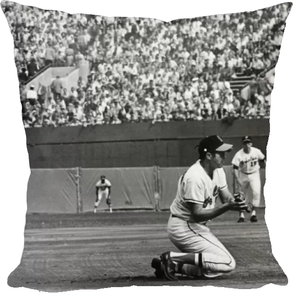 WORLD SERIES, 1970. Brooks Robinson, third baseman for the Baltimore Orioles, kneels to catch a ball hit by Johnny Bench of the Cincinnati Reds to end the top of the first inning of Game 3 of the 1970 World Series, at Memorial Stadium, Baltimore, Maryland, 13 October 1970
