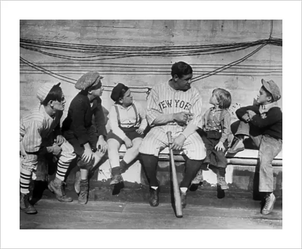 GEORGE H. RUTH (1895-1948). Known as Babe Ruth. American baseball player. Ruth talking to a group of children, while playing for the New York Yankees. Photograph, 1924