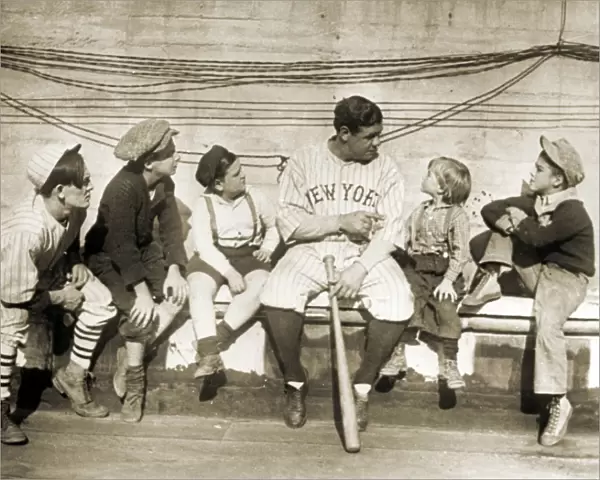 GEORGE H. RUTH (1895-1948). Known as Babe Ruth. American baseball player. Ruth talking to a group of children, while playing for the New York Yankees. Photograph, 1924