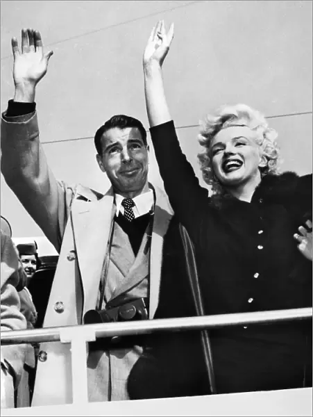 MONROE & DIMAGGIO, c1954. Marilyn Monroe and her husband Joe DiMaggio, waving to a crowd. Photograph, c1954