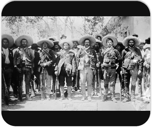 FRANCISCO PANCHO VILLA (1877-1923). Mexican revolutionary leader. Photographed wearing bandoliers with his military staff during the Mexican Revolution, c1913