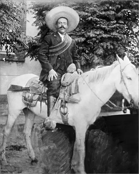 FRANCISCO PANCHO VILLA (1877-1923). Mexican revolutionary leader. Photographed wearing bandoliers mounted on a horse. Photograph, c1908-1919
