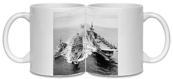 KOREAN WAR: SHIP REFUELING. The destroyer USS Shelton and the aircraft carrier USS Antietam refueling from the tanker USS Tolovana in Korean waters. The aircraft carrier USS Essex, in the the background, awaits her turn. Photograph, 1953