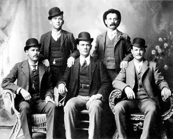 CASSIDY AND LONGBAUGH. Butch Cassidy (1866-?), alias of Robert Leroy Parker, American desperado, and Harry Longbaugh (1867-?), known as the Sundance Kid, American desperado. Cassidy (seated far right) and Longbaugh (seated far left) with members of their Wild Bunch, photographed at Fort Worth, Texas, in 1901
