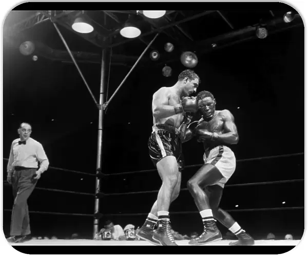 Rocky Marciano (left) defending his heavyweight title in a fight against Ezzard Charles at Yankee Stadium in the Bronx, New York City, 17 June 1954