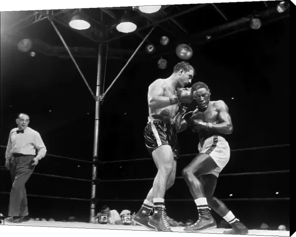 Rocky Marciano (left) defending his heavyweight title in a fight against Ezzard Charles at Yankee Stadium in the Bronx, New York City, 17 June 1954