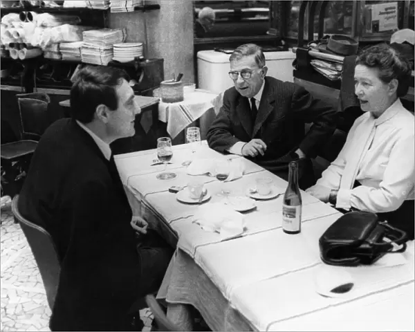 SARTRE & BEAUVOIR, 1964. French philosopher Jean-Paul Sartre and writer Simone Beauvoir having lunch at a cafe in Paris, 1964
