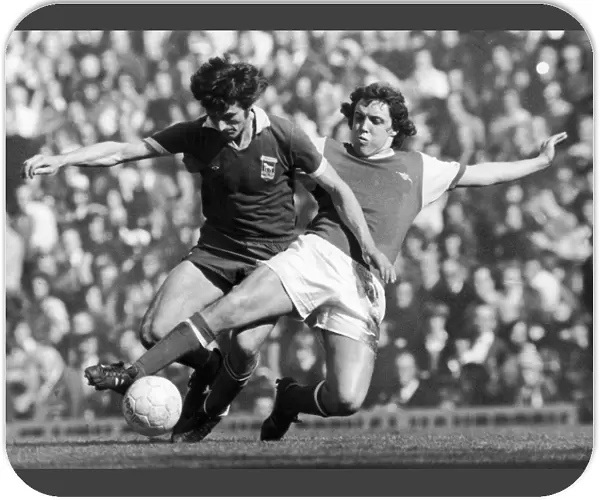 SOCCER TACKLE, 1976. Richie Powling of Arsenal FC (right) tackles a player of Ipswich Town FC during a soccer match in England, 1976