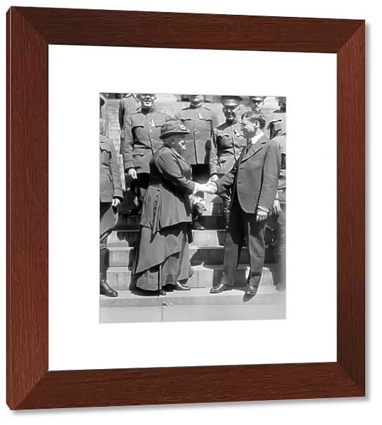 Womens rights reformer Anna Howard Shaw (left) shaking hands with Secretary of War Newton Baker in Washington, D. C. c1919