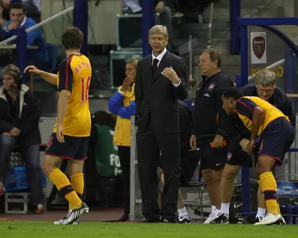 Arsenal manager Arsene Wenger talks to Aaron Ramsey during the match