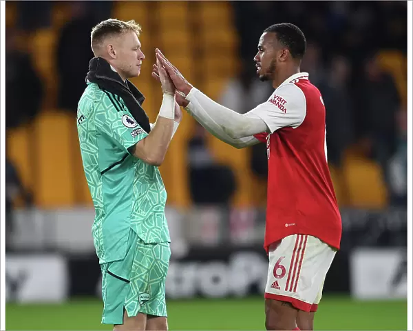 Arsenal's Gabriel Magalhaes and Aaron Ramsdale Celebrate Victory over Wolverhampton Wanderers in the 2022-23 Premier League