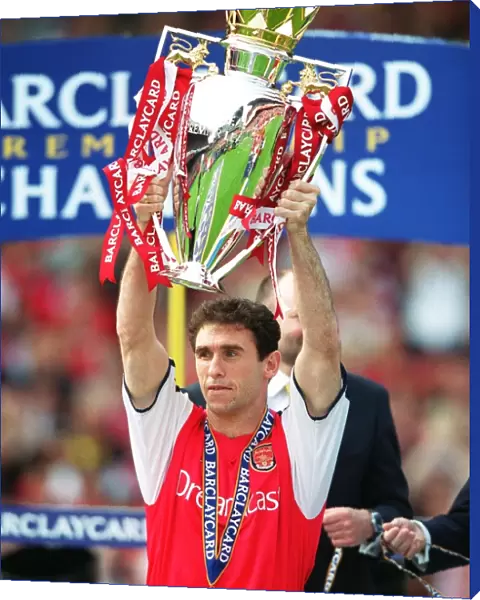 Martin Keown lifts the Premiership trophy after the match
