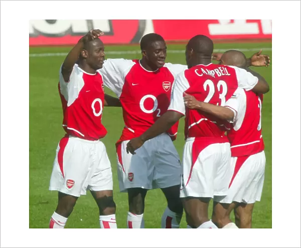 (L>R) Lauren, Kolo Toure, Sol Campbell and Ashley Cole celebrate at the end of the match