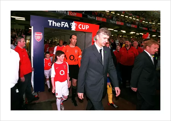 Arsene Wenger the Arsenal Manager leads to team out onto the pitch