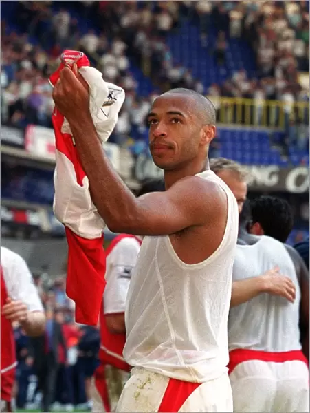 Thierry Henry celebrates pointing to his Badge. Tottenham Hotspur v Arsenal