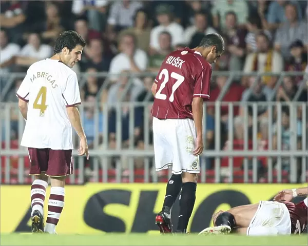 Cesc Fabregas (Arsenal) looks at injured Sparta Prague captain Tomas Repka