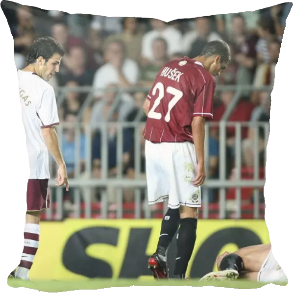 Cesc Fabregas (Arsenal) looks at injured Sparta Prague captain Tomas Repka