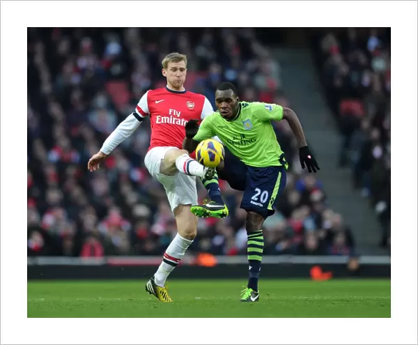Arsenal's Per Mertesacker Wins Ball from Aston Villa's Christian Benteke in Premier League Clash