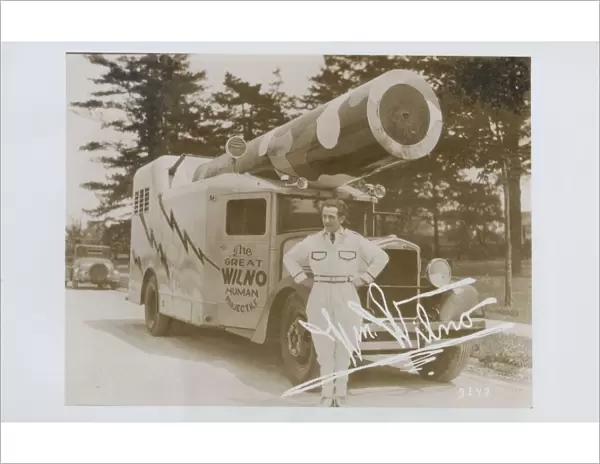 The Great Wilno. ca. 1935, USA, The Great Wilno, a human cannon ball, stands beside his specially designed truck mounted cannon