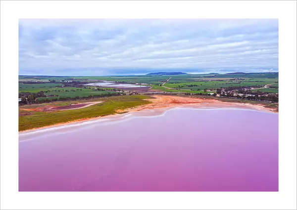 Aerial view of the green landscape, patterns, textures and amazing colors, pink, purple and orange over a Pink Salt Lake