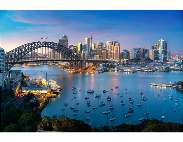 Cityscape image of Sydney, Australia with Harbor Bridge and Sydney skyline during sunset