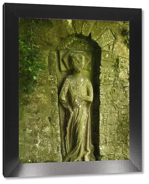 Sculpted figure in the old city wall