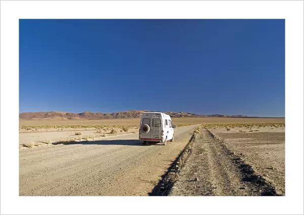 camper van on a desert road on the altiplano of argentina
