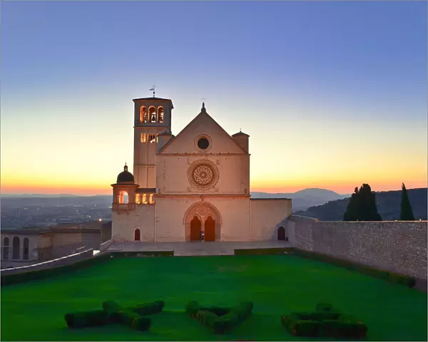 The sun sets behind St. Francis Basilica in Assisi