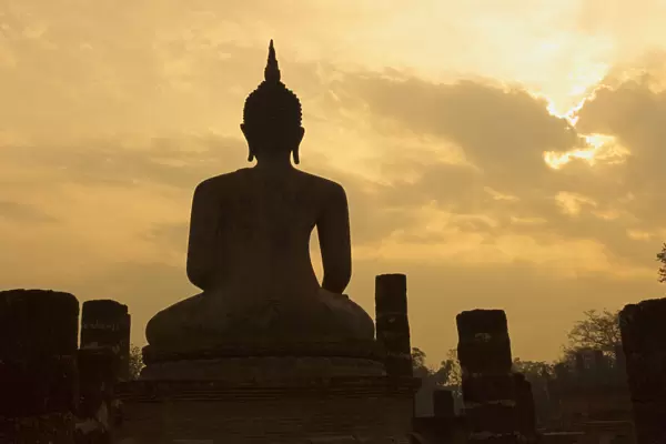Silhouette of buddha statue at sunset, Thailand
