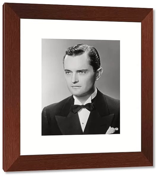 Elegant man posing in studio, (B&W), close-up, portrait