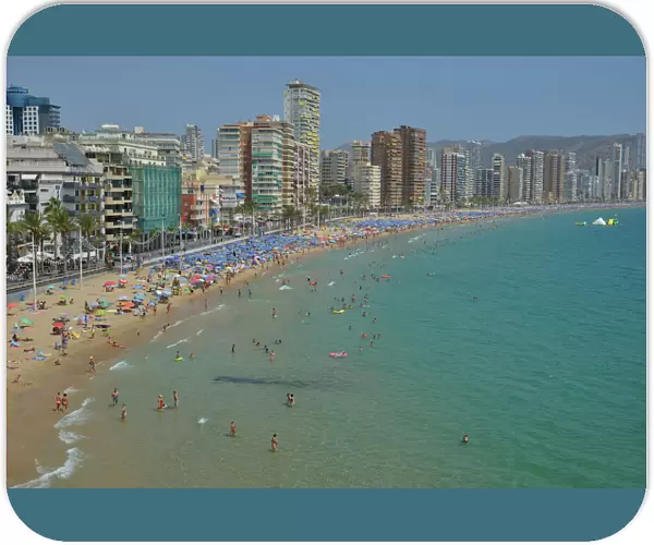 Bathers in front of big hotels on Playa Levante, Benidorm, Costa Blanca, Spain beach