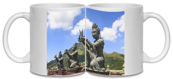 Statues of Devas making offerings at Tian Tan Buddha image at Po Lin Monastery, Lantau Island, Hong Kong, China