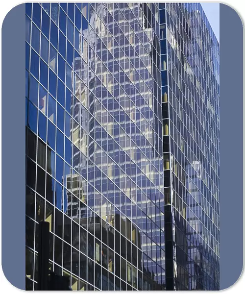Reflections in a modern glass and steel office tower building, Montreal, Quebec, Canada