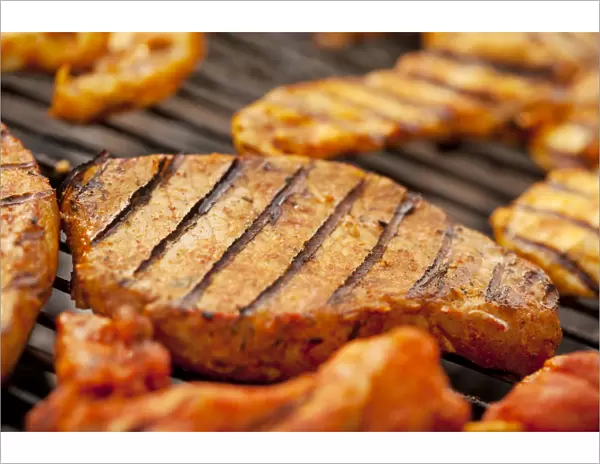 Grilled meat, marinated turkey breast and beef steaks on a grill