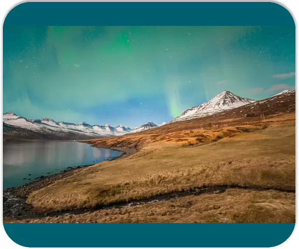 Aurora borealis over the beautiful mountains fjord of Iceland