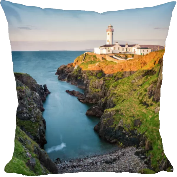Fanad Head (FAanaid) lighthouse, County Donegal, Ulster region, Ireland, Europe. Lighthouse and its cove at sunset