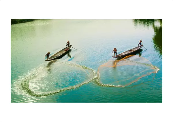 Fishermen catch fish in the river in Hue, Vietnam