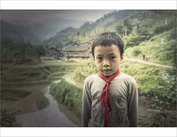 Chinese boy standing in rice paddy fields