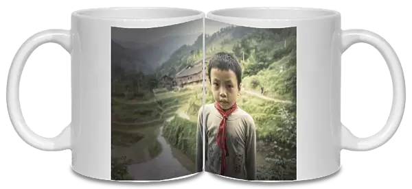 Chinese boy standing in rice paddy fields