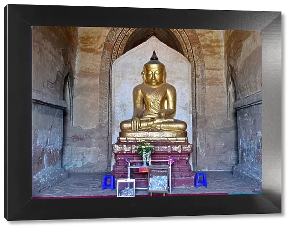 Gold buddha inside Dhamma Yan Gyi entrance Temple, Bagan, unesco ruins Myanmar. Asia