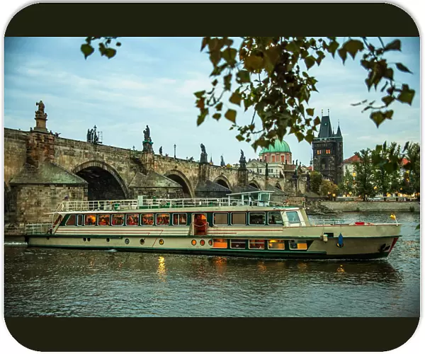Charles bridge in Prague and a tourist boat