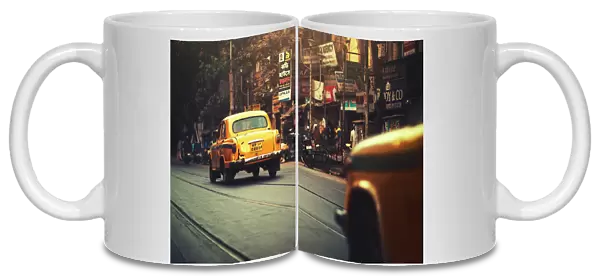 Yellow taxi cab on the street of Kolkata India
